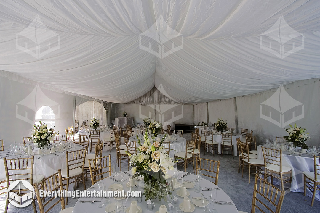 Wedding Tent with Liner Interior view of a draped wedding tent with tables and ballroom chairs