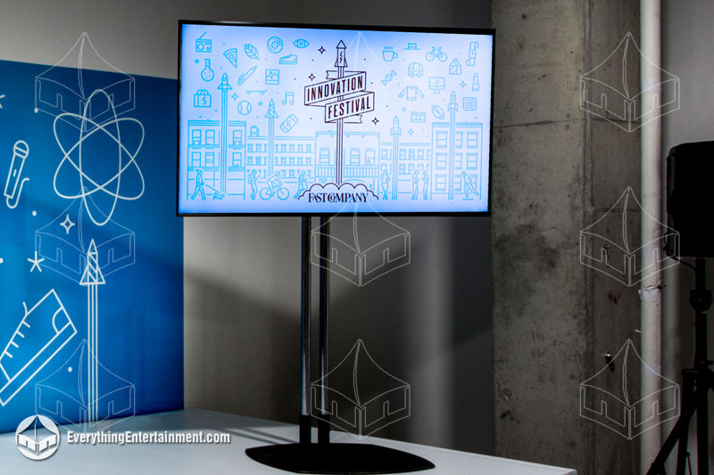 flat-screen-on-corporate-stand Flat screen monitor with white stage at corporate event