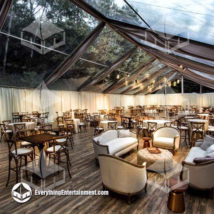 Clear tent with hardwood floor Huge clear top tent with rustic party rentals setup on a hardwood floor.