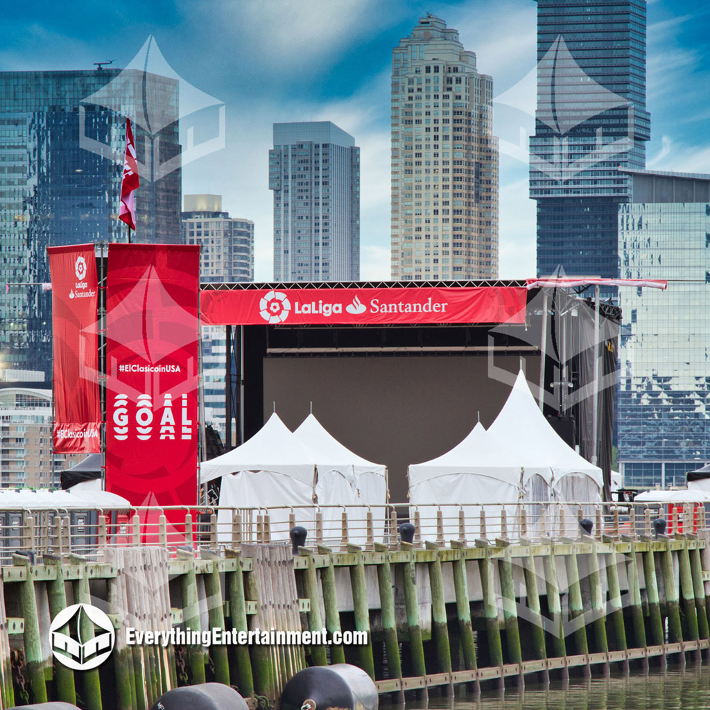 tents on nyc pier several high peak tents on pier in NYC with NJ skyline in background.