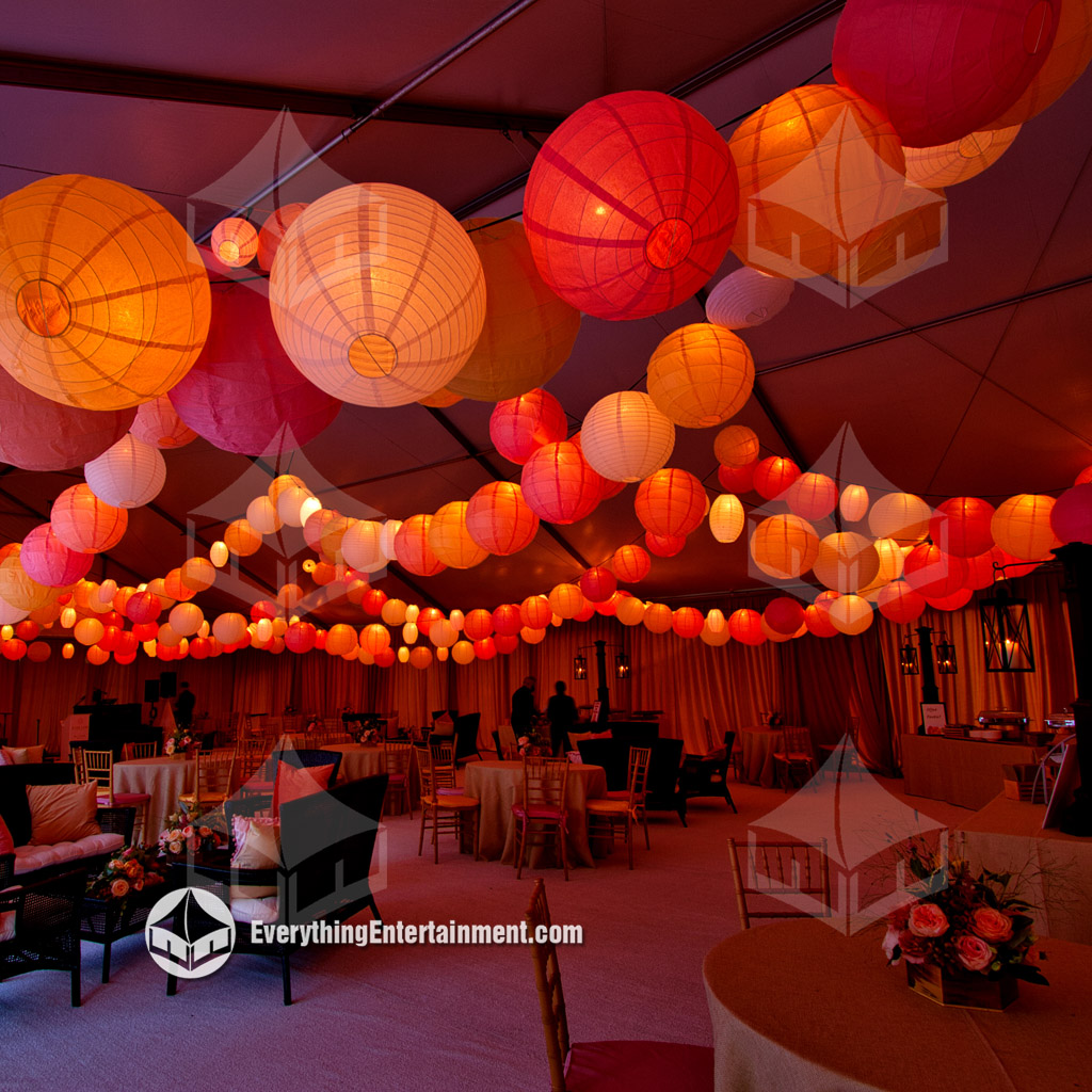 Tent with Paper Lanterns A large white wedding tent interior with colorful paper lanterns