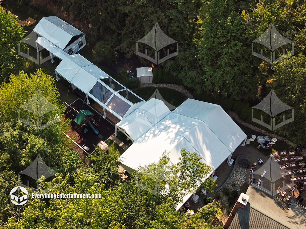multiple tents in backyard An aerial view of multiple tents in a backyard linked together.