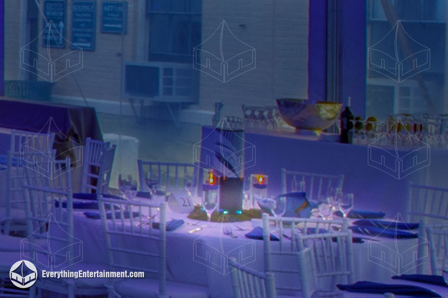 pin-spot-lit-table Table with pin spot lighting, in a tent washed with blue lights