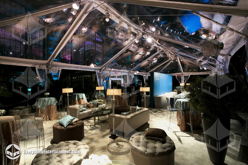 A sophisticated 30x75 clear-top tent with custom lighting, flooring, and furniture for client appreciation events.
