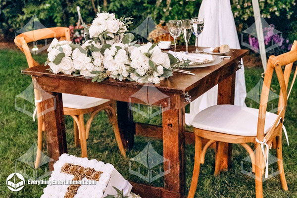 farm-table square farm table with cross-back chairs and floral decor