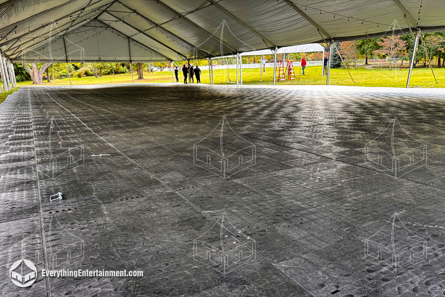 Temporary interlocking sub-floor under a 50x120 foot tent