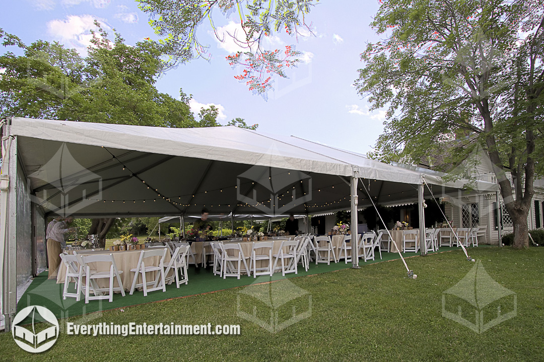 White Wedding Tent with Tables and Chairs White wedding tent with tables and chairs setup on a grass lawn