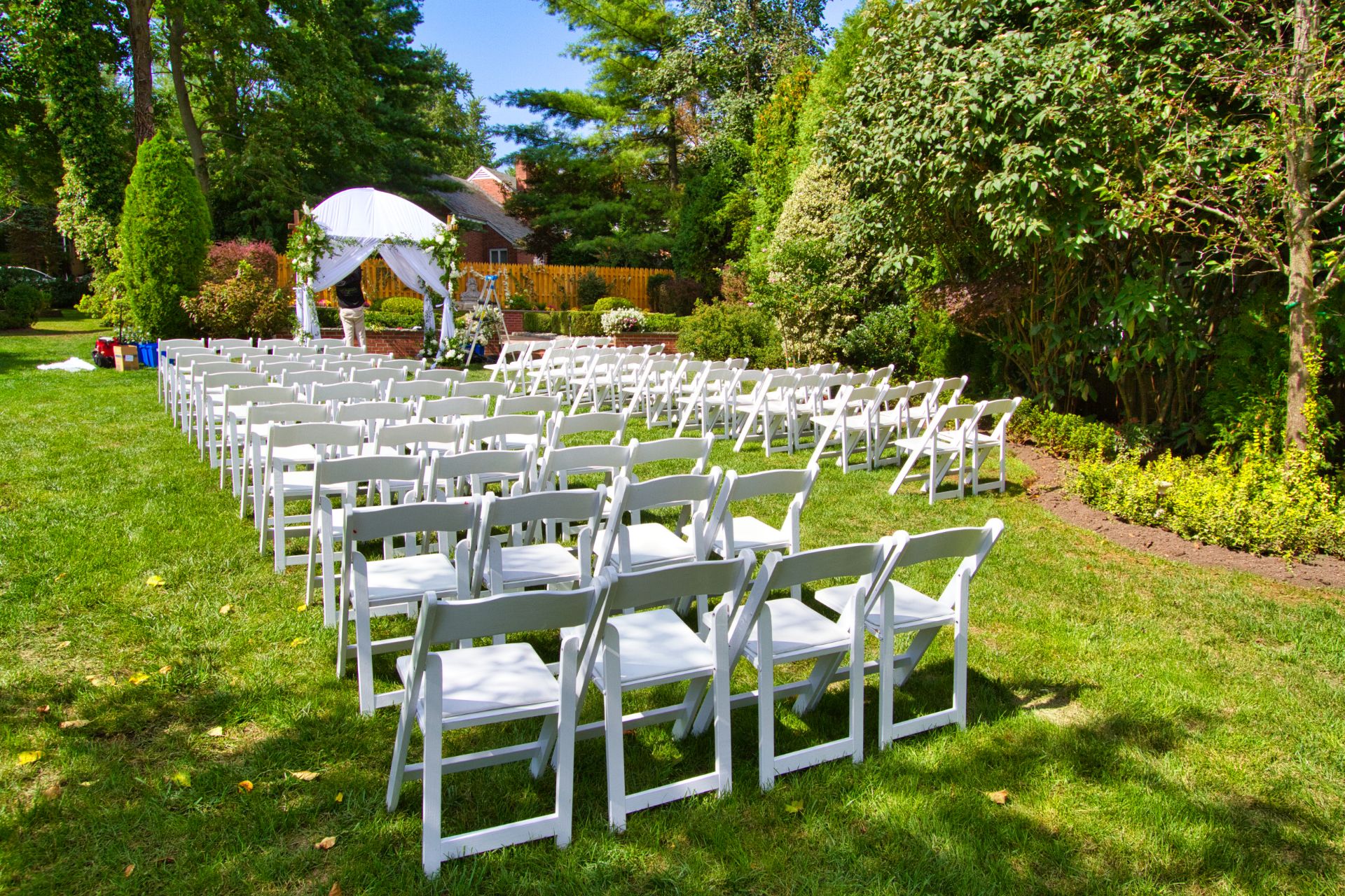white chairs for wedding ceremony Garden Chairs setup for wedding ceremony on grass